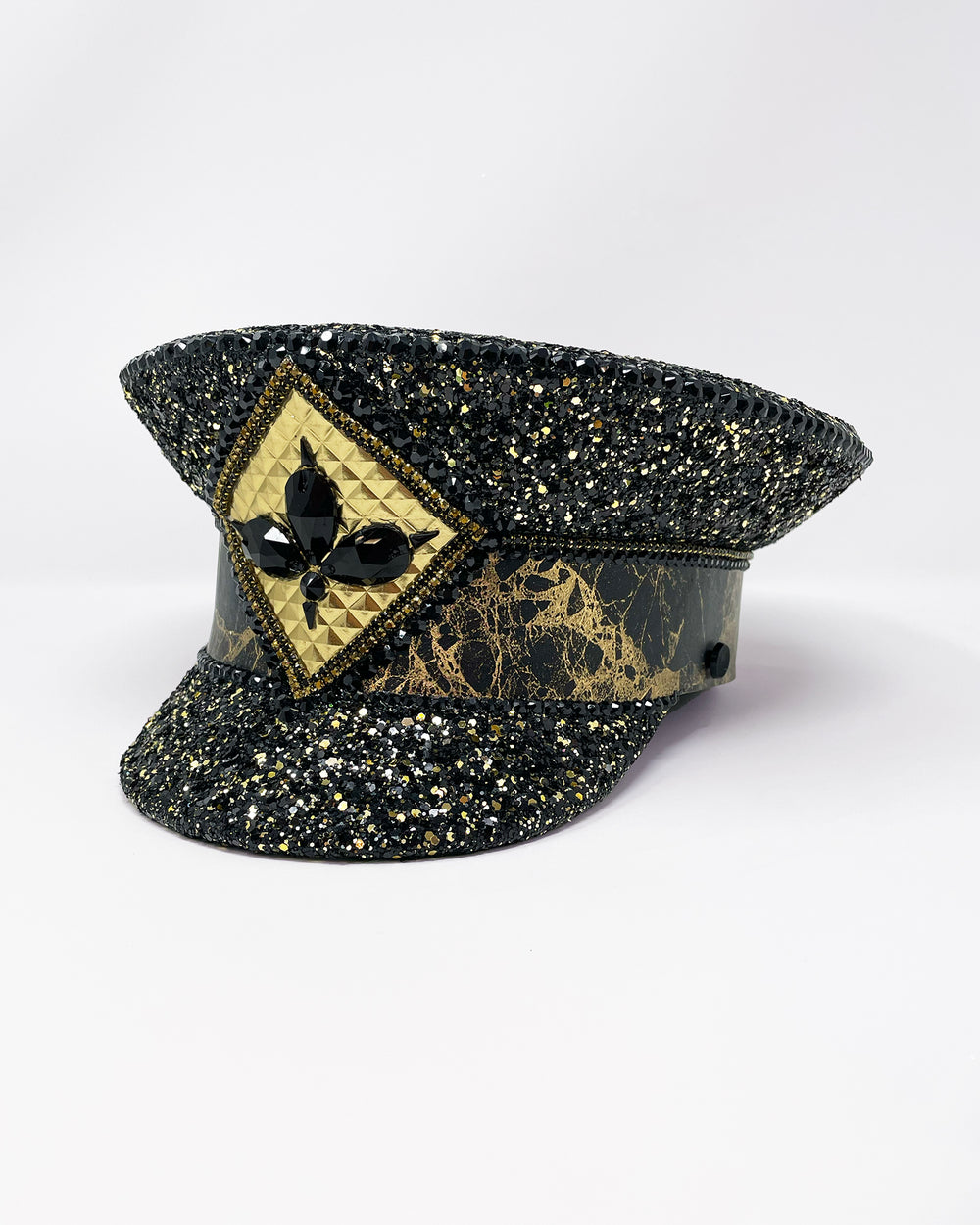 Authentic up cycled military captain hat, fully lined, hand embellished with black and gold glitter mix, beautifully hand detailed with gold and brown marble effect faux leather, gold leatherette, crystals and rhinestones. costume hat, festival hat, festival outfit, statement hat, high end hats, high end party wear, where to buy captain hats, stage wear, unique fashion, custom stage wear, festival essentials, festival headwear, halloween outfit, burning man hat, army hat, made in the UK