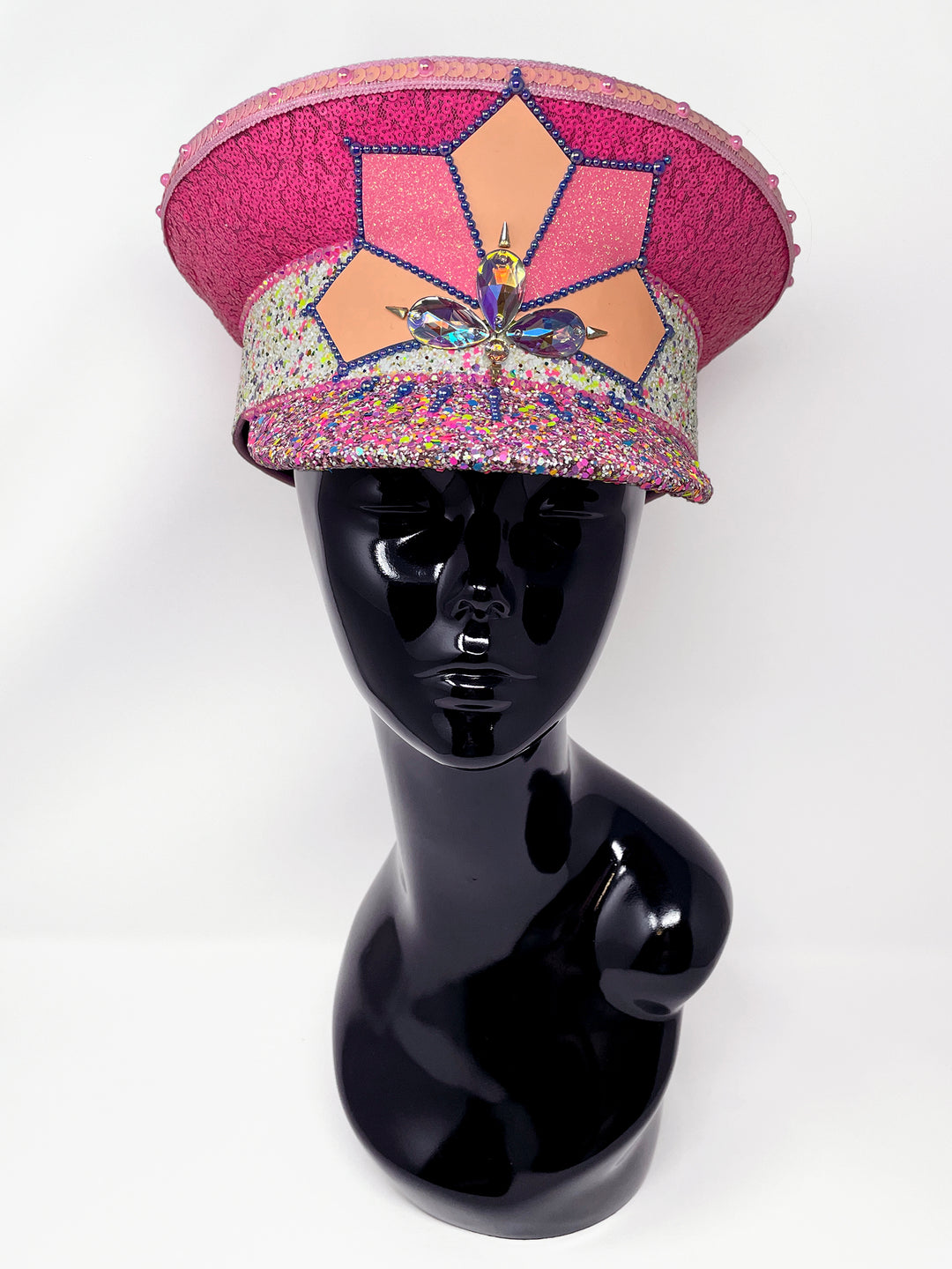 Festival captain hat with pink sequins, colourful glitter peak, Jukebox logo jewel detail, and glow-in-the-dark reflective starburst design – perfect for rave, costume, or party wear. Festival 
fashion,, stage wear