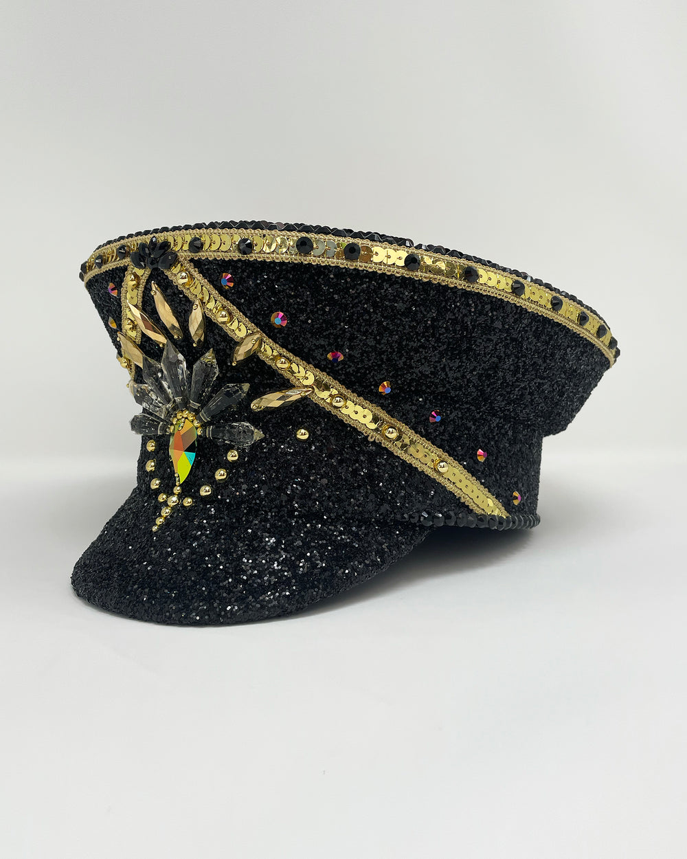 Black and Gold captain hat. Authentic up cycled military hat, fully lined, hand embellished with black glitter mix. Black gold flip sequin top, hand detailed with sequin trim, crystals and rhinestones. costume hat, festival hat, festival outfit, statement hat, high end hats, high end party wear, where to buy captain hats, stage wear, unique fashion, festival essentials, festival headwear, halloween, burning man hat, army hat, rave outfit, festival style, unique fashion, mermaid sequin, hats for rent