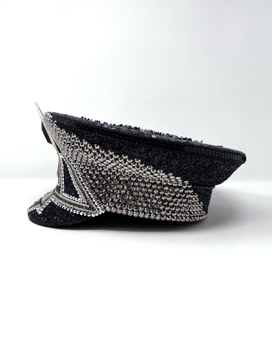 Black and silver Bermuda captain hat. Authentic up cycled military hat embellished with glitter, silver motive and rhinestones. Stage wear, rave outfit, costume hat, sequin hat, festival wear, statement hat, unique festival hat, handmade hat, costume hat, reworked, best captain hats, army hat, handmade in the UK, high end hat, high end party, halloween hat, halloween outfit, festival fashion, festival style, festival outfit