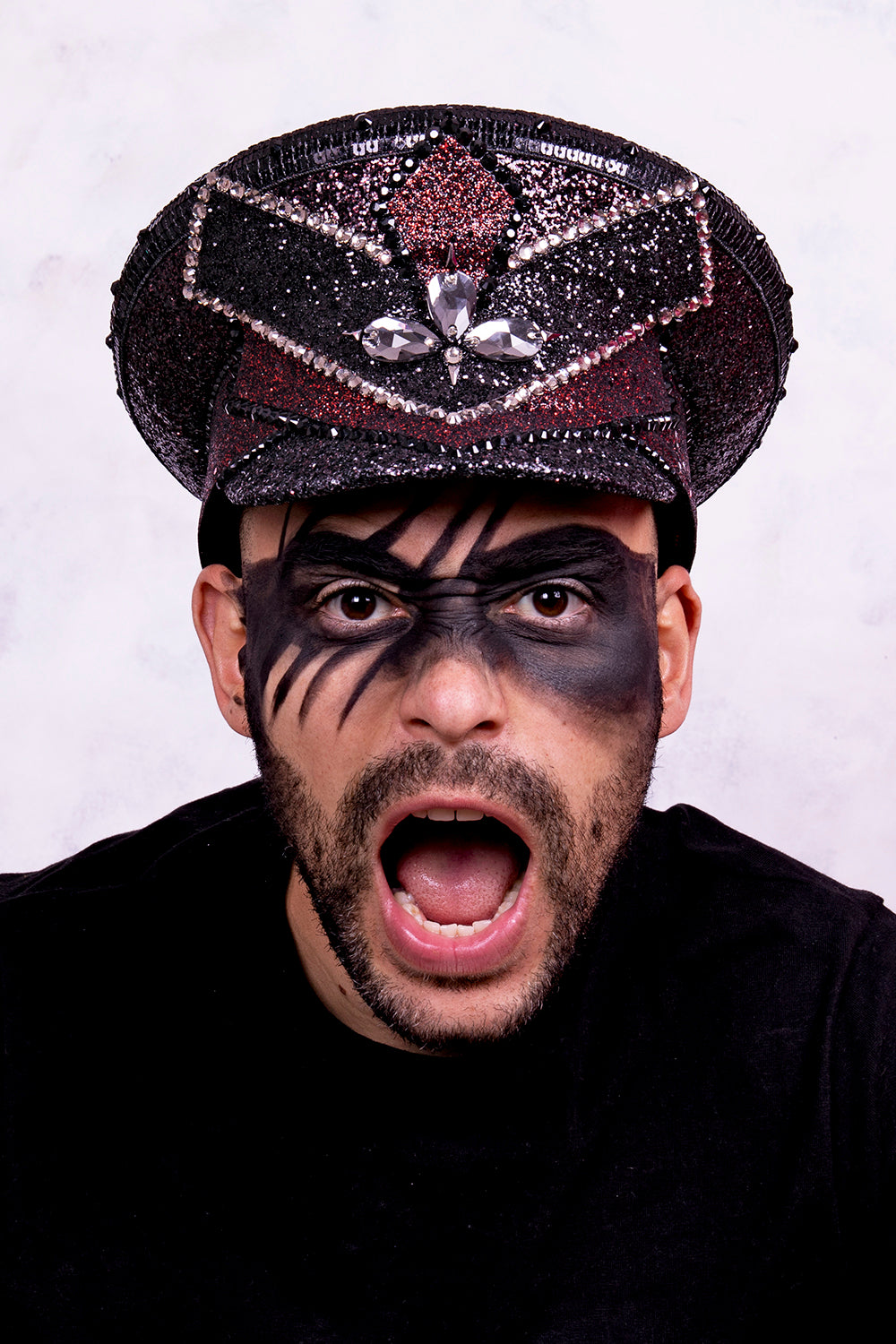 Black and red captain hat, Authentic up cycled military hat, fully lined, hand embellished with black and red glitter mix, beautifully hand detailed with black and red glitter faux leather, square sequin trim, crystals and rhinestones. costume hat, festival hat, festival outfit, statement hat, high end hats, high end party wear, where to buy captain hats, stage wear, unique fashion, custom stagewear, festival essentials, festival headwear, halloween outfit, burning man hat, army hat, made in the UK, rave