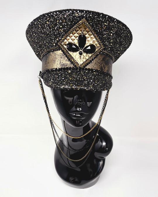 Authentic up cycled military captain hat, fully lined, hand embellished with black and gold glitter mix, beautifully hand detailed with gold and brown marble effect faux leather, gold leatherette, crystals and rhinestones. costume hat, festival hat, festival outfit, statement hat, high end hats, high end party wear, where to buy captain hats, stage wear, unique fashion, custom stagewear, festival essentials, festival headwear, halloween outfit, burning man hat, army hat, made in the UK