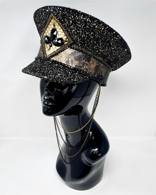 Authentic up cycled military captain hat, fully lined, hand embellished with black and gold glitter mix, beautifully hand detailed with gold and brown marble effect faux leather, gold leatherette, crystals and rhinestones. costume hat, festival hat, festival outfit, statement hat, high end hats, high end party wear, where to buy captain hats, stage wear, unique fashion, custom stagewear, festival essentials, festival headwear, halloween outfit, burning man hat, army hat, made in the UK