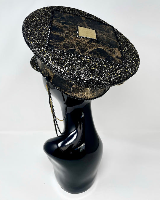 Authentic up cycled military captain hat, fully lined, hand embellished with black and gold glitter mix, beautifully hand detailed with gold and brown marble effect faux leather, gold leatherette, crystals and rhinestones. costume hat, festival hat, festival outfit, statement hat, high end hats, high end party wear, where to buy captain hats, stage wear, unique fashion, custom stagewear, festival essentials, festival headwear, halloween outfit, burning man hat, army hat, made in the UK